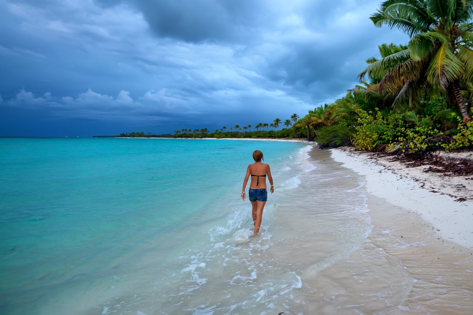 Teenage girl walks on beach in Dominican Republic